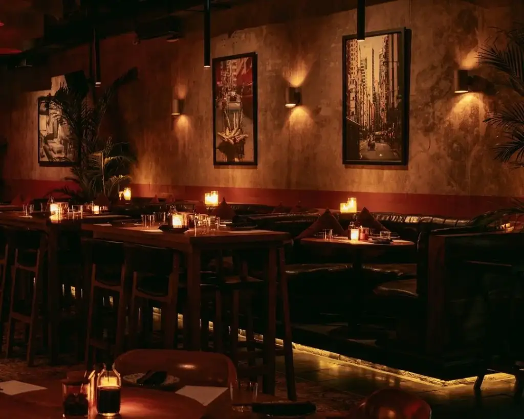 Quiet nightlife in Ubud bar with warm candlelit tables, rustic decor, and cozy seating